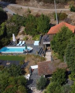 an aerial view of a house with a swimming pool at Bela Vista Alqueve - 2 houses with pool, 2 casas com piscina in Arganil