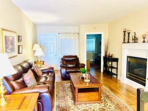 a living room with leather furniture and a fireplace at River Place Condos #204 2BD in Pigeon Forge