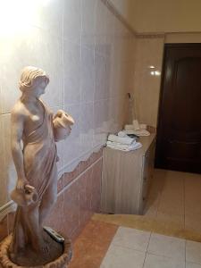 Uma estátua de uma mulher numa casa de banho. em La Suerte em Sant'Egidio del Monte Albino