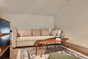 a living room with a couch and a table at Martis Forum Heritage Hotel & Residence in Poreč