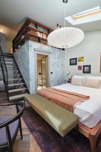 a bedroom with a large bed and a staircase at Martis Forum Heritage Hotel & Residence in Poreč