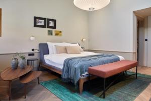 a bedroom with a bed and a table and chairs at Martis Forum Heritage Hotel & Residence in Poreč