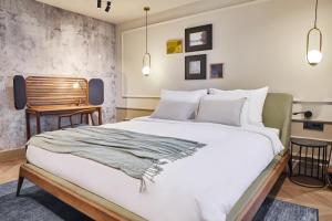 a bedroom with a large bed and a chair at Martis Forum Heritage Hotel & Residence in Poreč