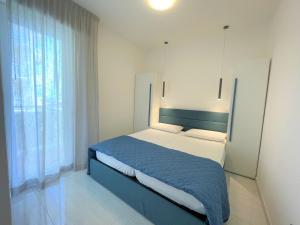 En eller flere senge i et værelse på Condominio Girasole + 11 billeder