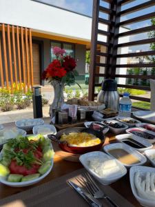 a table topped with plates of food on a table at Güven Park Residance & Apart Hotel in Kemer