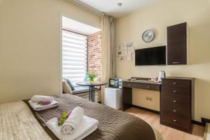 a bedroom with a bed and a desk and a sink at Egyptian House in Saint Petersburg