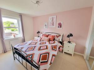 a bedroom with a large bed and a window at Homely Three Bed Holiday Home in Glasgow in Glasgow