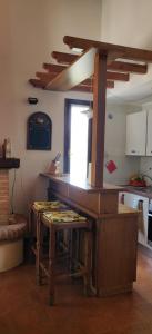 a kitchen with a wooden table in a room at Appartamento Arcobaleno in Folgaria