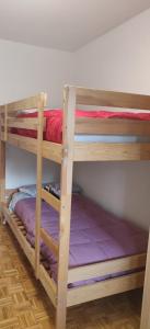 a couple of bunk beds in a room at Appartamento Arcobaleno in Folgaria