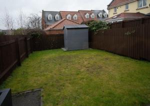 a backyard with a fence and a small shed at The Hideaway Sherburn in Elmet in Sherburn in Elmet