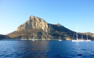 a view of a mountain with boats in the water at Casa Clio in Favignana
