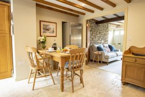 a kitchen and living room with a wooden table and chairs at Fairview in Ampleforth