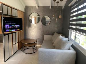 a living room with a couch and a table and a mirror at Loft 2023 in Villa Carlos Paz