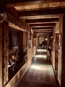 a hallway of an old wooden building with a long corridor at Relais du Chateau Blanc in La Thuile