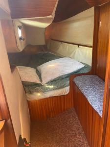 mały pokój z łóżkiem i siedziskiem w obiekcie Mettre les voiles à Deauville w mieście Deauville