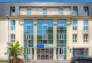 an office building with a balcony on top of it at The Originals City, Hôtel Les Thermes de l'Avenue, Dax in Dax