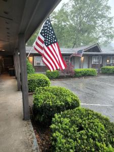 a american flag flying in the yard of a house at The Inn at Shady Lawn in Newland