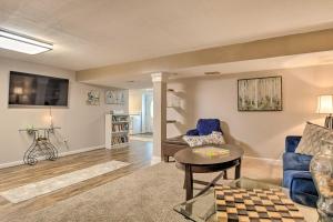 a living room with a blue couch and a table at Bel Air Apartment with Pool about 2 Mi to Main St in Bel Air