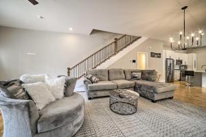 a living room with two couches and a staircase at Well-Appointed Pittsburgh Home 1 Mi to Dtwn! in Pittsburgh