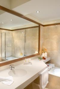 a bathroom with a sink and a shower and a tub at Volos Palace in Volos