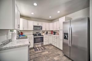 a kitchen with white cabinets and a stainless steel refrigerator at Welcoming Carlsbad Home Near Parks and Town! in Carlsbad