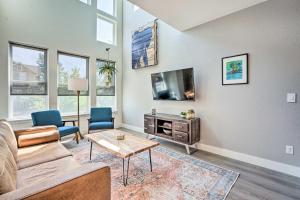 a living room with a couch and a tv at Spacious Old Town North Home with Rooftop Deck! in Fort Collins