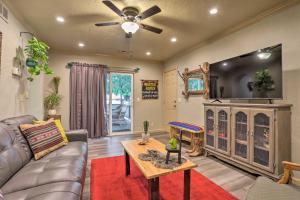 a living room with a couch and a flat screen tv at Colorado Cowboy Cottage 12 Mi to Dtwn Denver in Northglenn