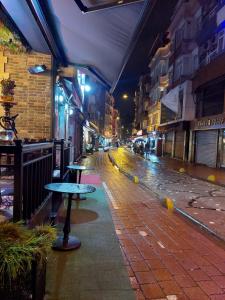 an empty city street at night with a table at Çelebi Suite Home in Istanbul