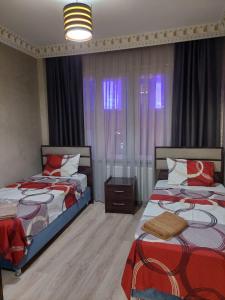 1 dormitorio con 2 camas y una ventana con cortinas en Çelebi Suite Home en Estambul