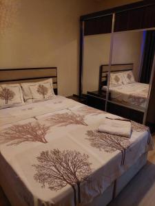 a bedroom with a large bed with trees on it at Çelebi Suite Home in Istanbul
