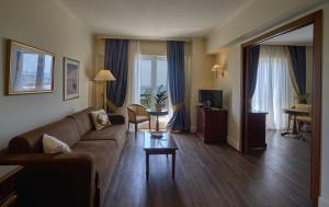 a living room with a couch and a table at Volos Palace in Volos