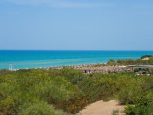 a view of a beach with the ocean in the background at Sikania Resort & Spa in Licata