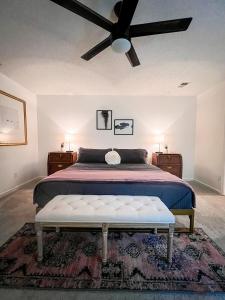 a bedroom with a bed with a ceiling fan at The Mini Mansion at Graceland in Memphis