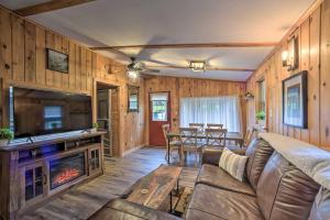 a living room with a couch and a fireplace at Glamping Getaway in Woodstock Lake Campground 