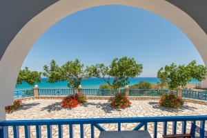 a view of the ocean from the balcony of a resort at Blue House Apartments in Vasilikos