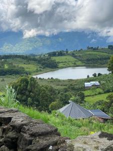 a view of a lake on a hill with a house at Saka Laka in Fort Portal
