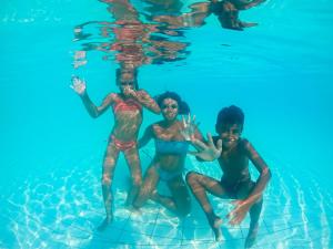 a group of children playing in a swimming pool at Sikania Resort & Spa in Licata