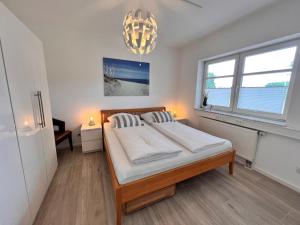 a bedroom with a large bed and a large window at Veens Crew Home 4 Pax in Dreieich