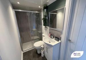 a bathroom with a shower and a toilet and a sink at Luke Stays - Pembroke Avenue in Walker Gate