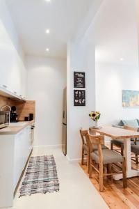 a kitchen and dining room with a table and chairs at BEAUTIFUL ΝΕW CENTRAL APPARTMENT in Athens