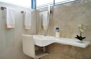 a bathroom with a sink and a mirror at Augusta Palms - White Room in Centurion