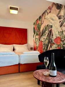 a hotel room with a bed and a table with a wine glass at Lazar Winery Tourism B&B in Rosoman