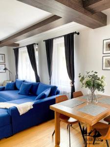 a blue couch in a living room with a table at Vidik B30 in Kopaonik