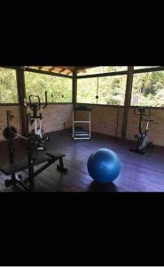 a gym with a blue pilates ball and weights at Casa Pé na Areia in Pauba