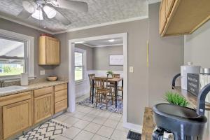 a kitchen with a sink and a dining room at Cozy Cottage Near Dtwn Dining, Walk to Casino in Bristol