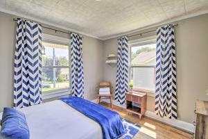 a bedroom with blue and white curtains and a bed at Cozy Cottage Near Dtwn Dining, Walk to Casino in Bristol