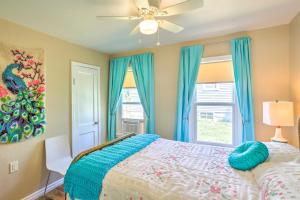 a bedroom with a bed with a ceiling fan and a window at Modern Rapid City Duplex Less Than 10 Mi to Natl Forest! in Rapid City