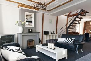 a living room with two chairs and a fireplace at Canal Holiday Apartment in Amsterdam