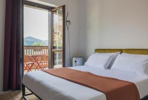 a bedroom with a bed with a view of a balcony at Hotel Dolomiti in Castelmezzano