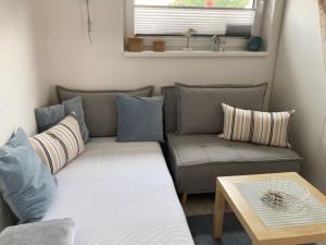 a living room with a couch and a table at Apartmán Nad Přehradou in Frýdek-Místek